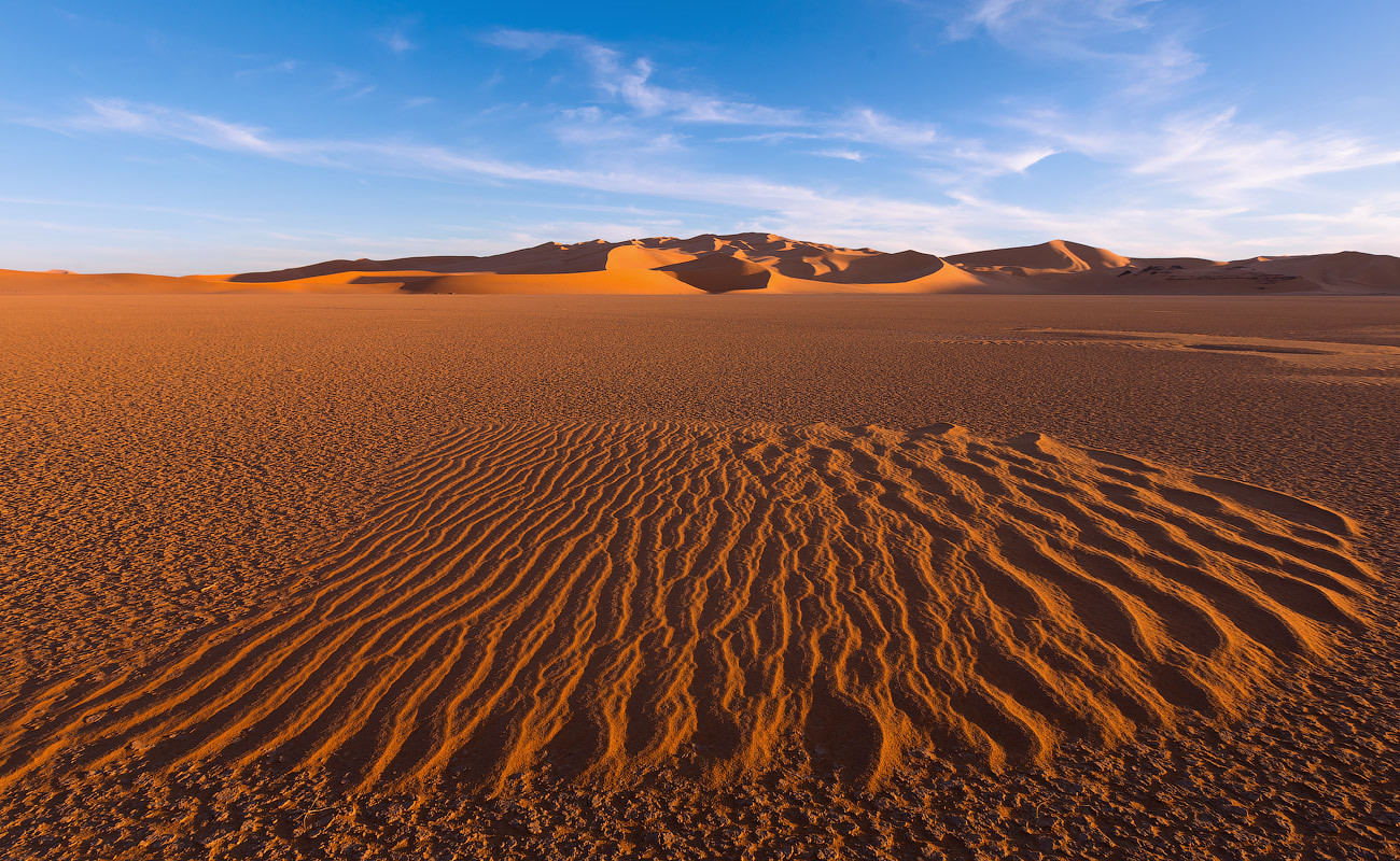 The Sahara is not only huge sand dunes, but also hard, stony deserts, with rare sediments of sand.