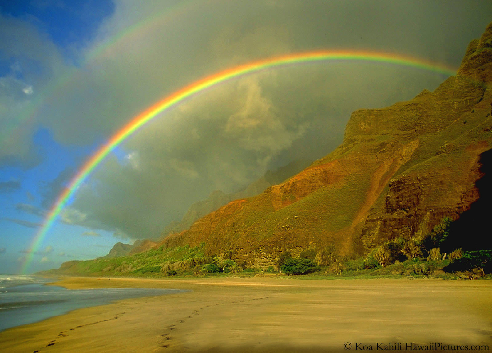 Double rainbow on the mountains by the ocean
