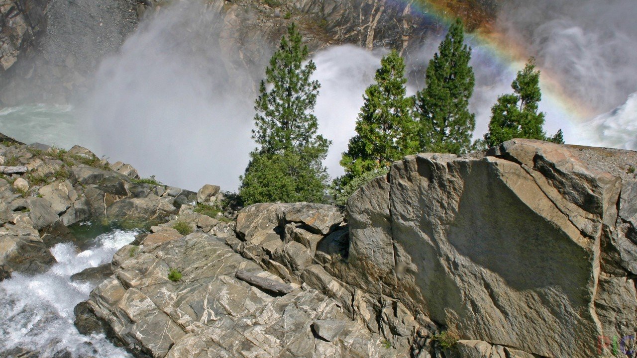 Rainbow at the turbulent mountain river