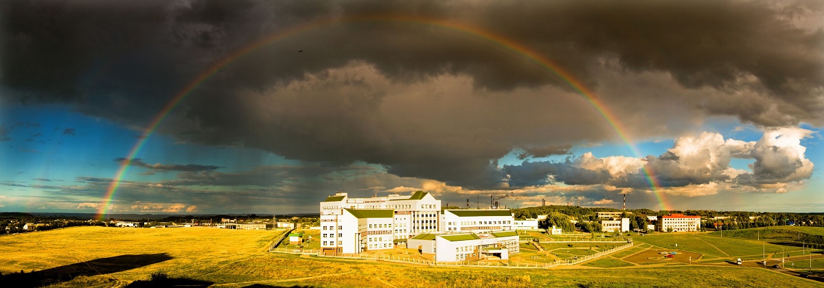 Panoramic shot: a rainbow over the town