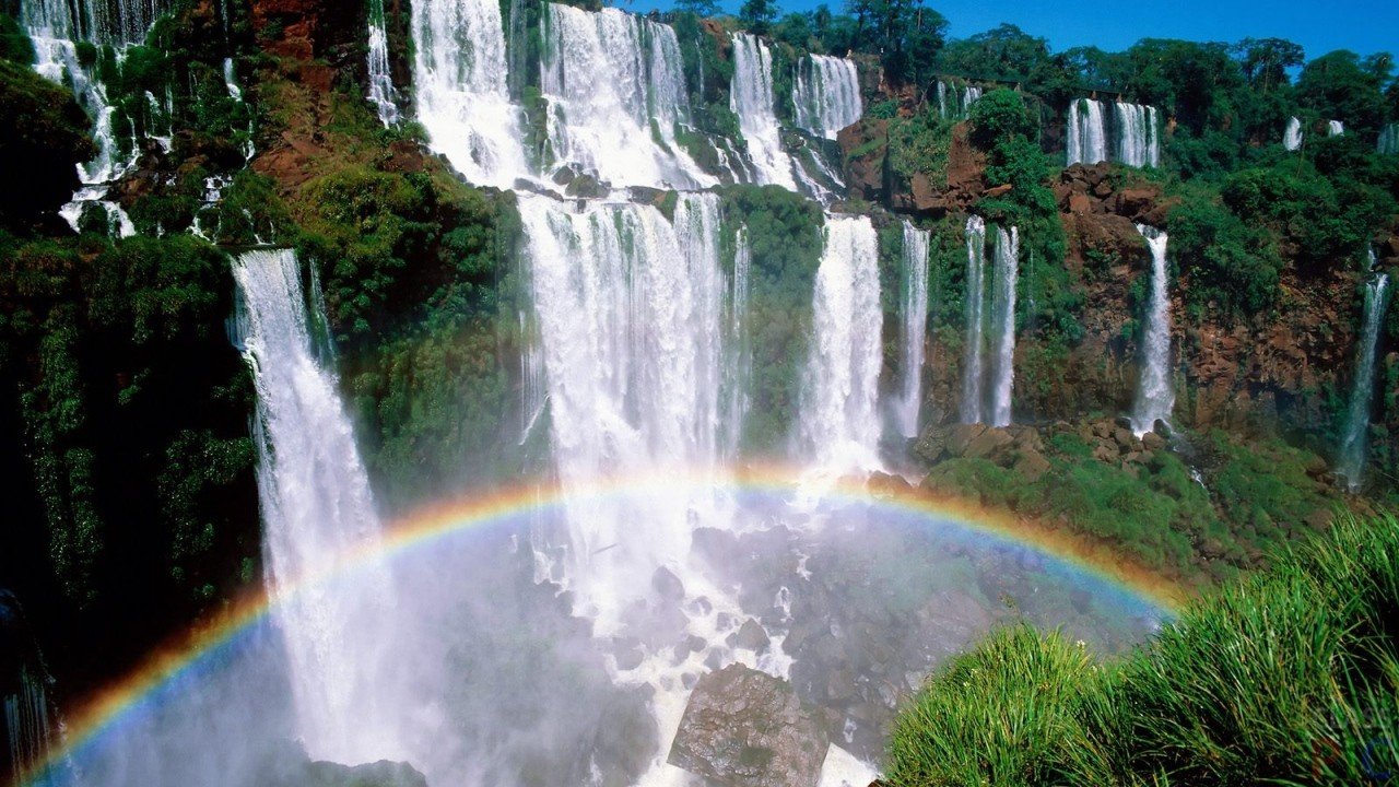 Rainbow over Iguazu, a complex of 275 waterfalls on the Iguazu River, lo...