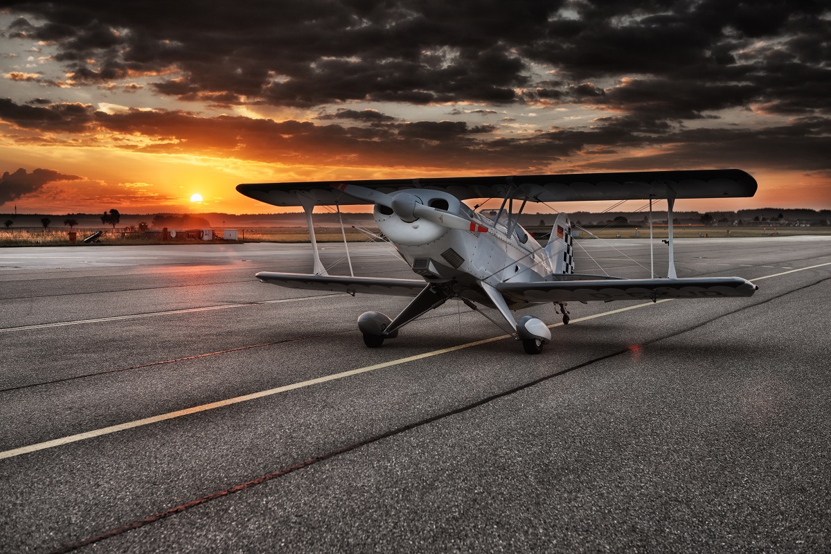Photo of a small plane at sunset