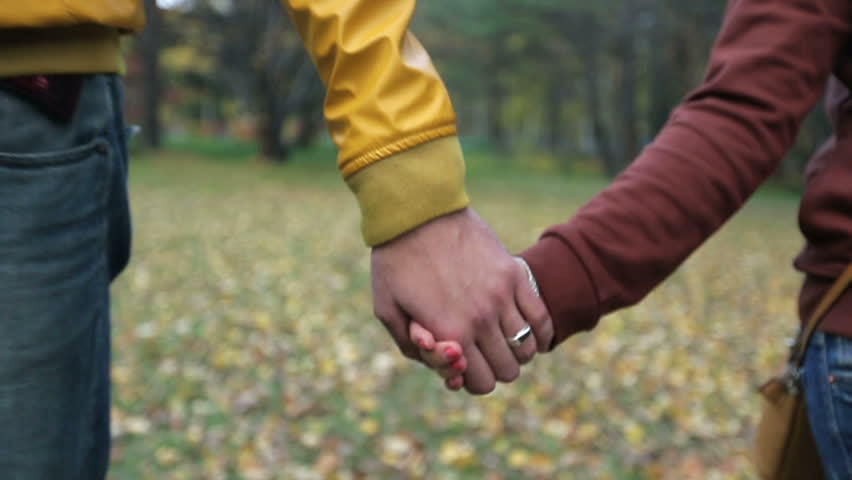 Boy and girl hold hands