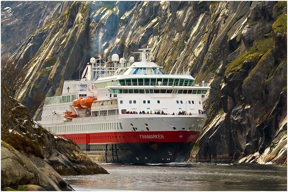 Cruise liner goes along the fjord of Norway
