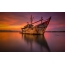The sunken ship in the bright colors of the setting sun