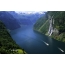 Cruise liner goes along the fjord, top view