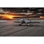 Foto van een klein vliegtuig bij zonsondergang